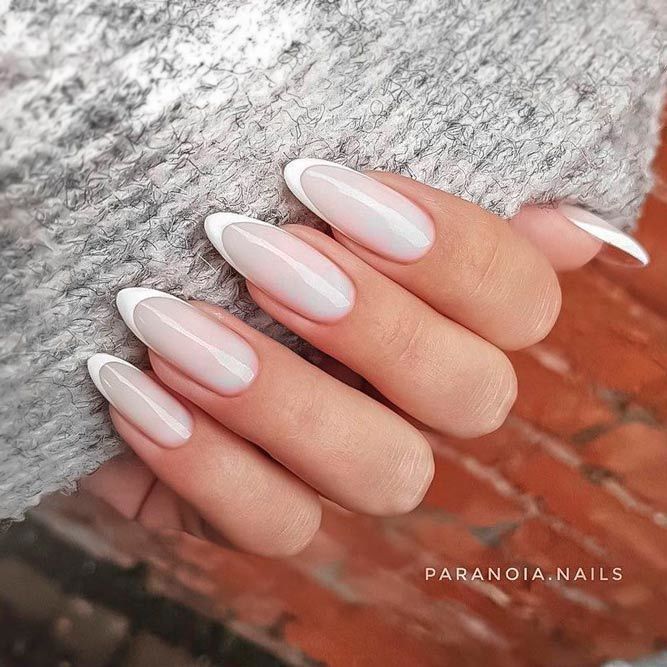 Sophisticated Almond-Shaped Ombre Nails with Delicate White Tips and Translucent Base.