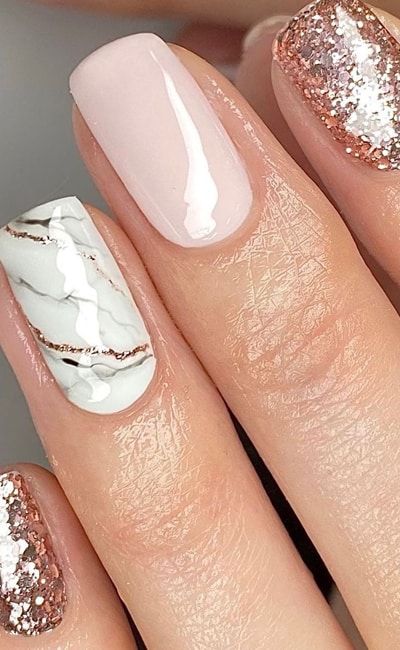 Sophisticated Nail Design with Soft Pink Marble and Glittery Rose Gold Accents.