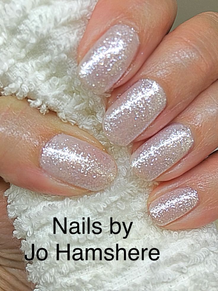 Elegant Glittery Nail Design with Soft Iridescent Finish for Versatile Occasions.