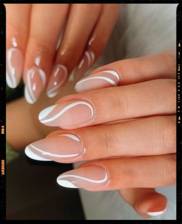 Chic Elegant Nail Design: Transparent Base with White Detailing and Modern Swirls.