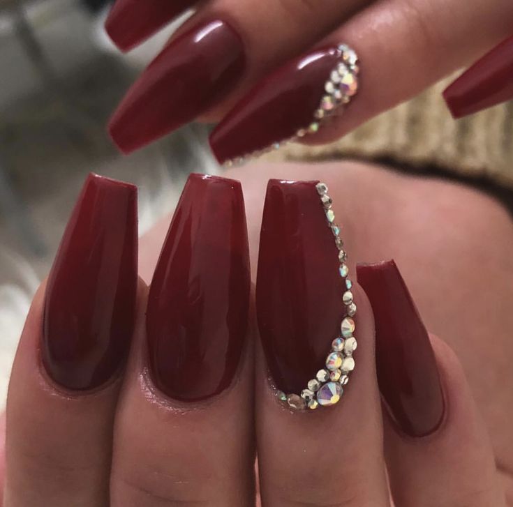 Bold and Glamorous: Elegant Burgundy Stiletto Nails with Rhinestone Embellishment