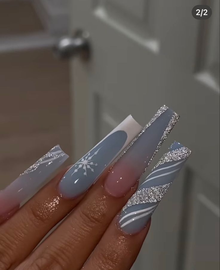 Chic Winter Nail Design: Soft Blue and White with Snowflakes and Shimmering Glamour.