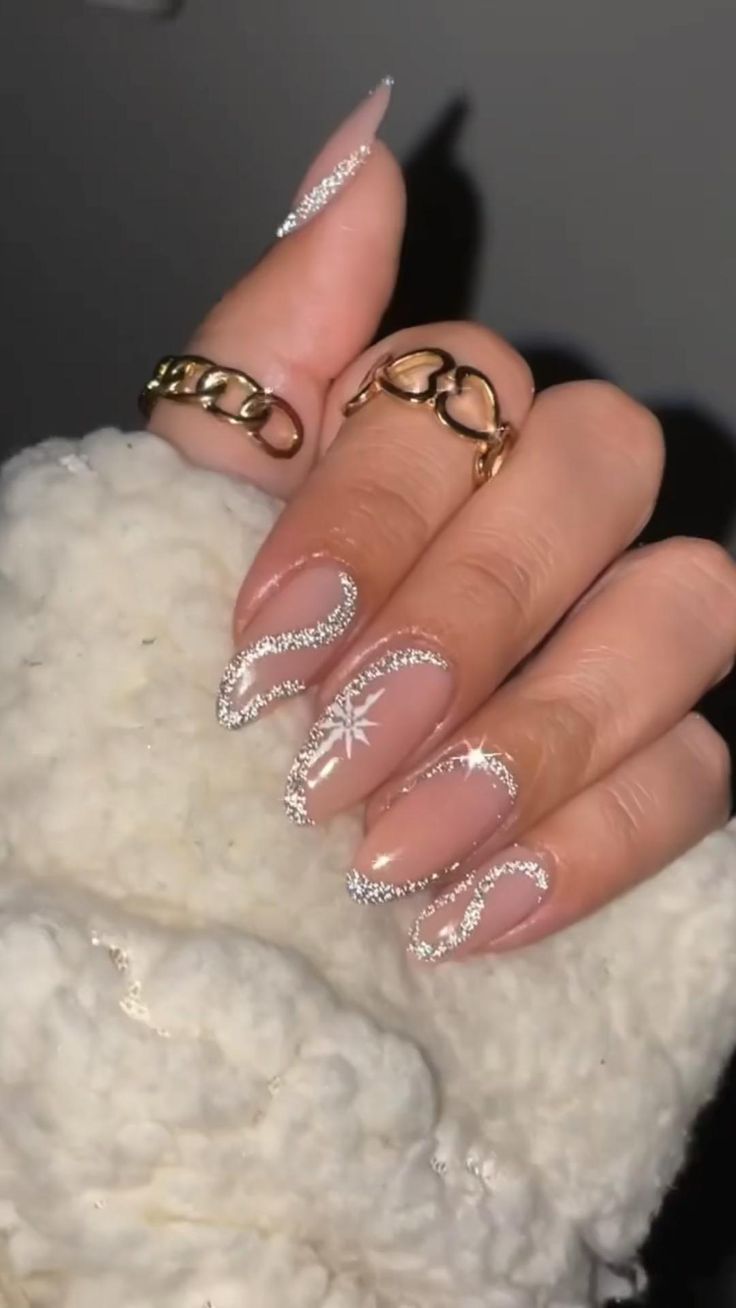 Chic Winter Nail Design: Soft Nude Base with Shimmering Silver Accents and Delicate Snowflakes.