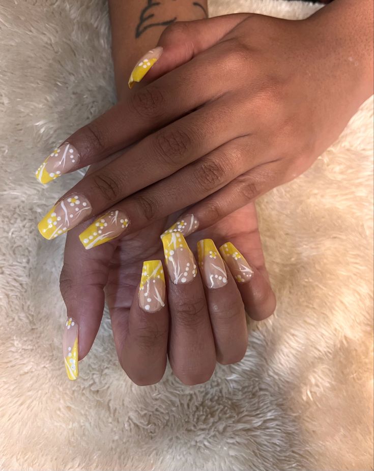 Bold Floral Nail Design: Yellow Accents on Soft Nude Base for a Playful, Elegant Look.