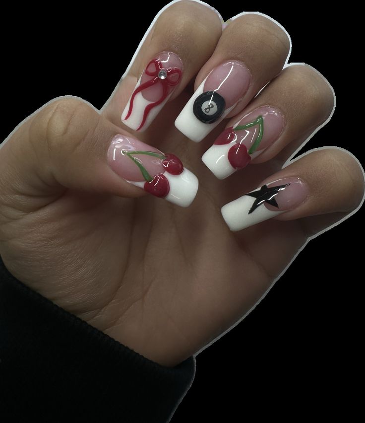 Playful Nail Design: Glossy White Tips with Vibrant Red Cherries and Delicate Black Star Elegance.