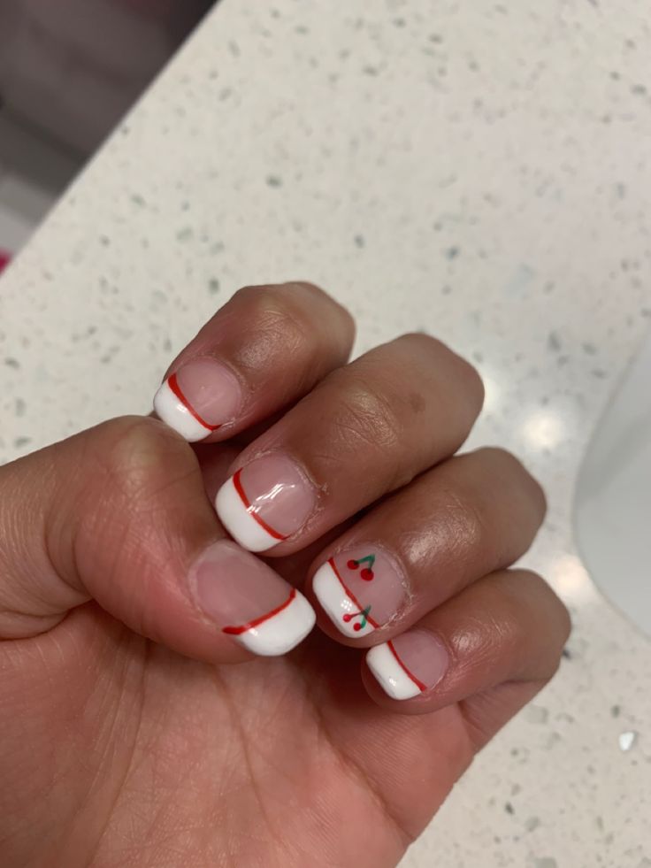 Festive Holiday-Inspired Nail Design with Glossy White Base and Red Accents