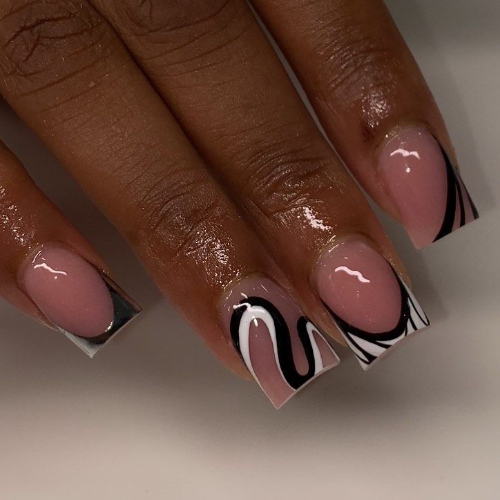 Chic Nail Design: Elegant Soft Pink and Bold Black Accents with Intricate Patterns.