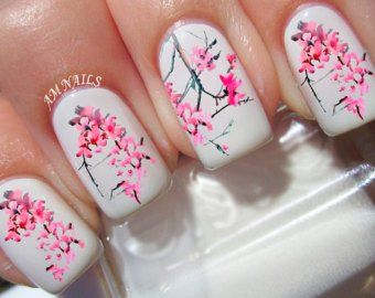 Elegant Floral Nail Design with Pink Cherry Blossoms on White Background