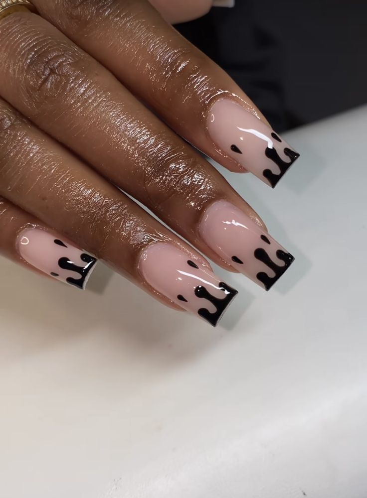 Bold Black Drip Nail Design on Nude Base: A Striking Fusion of Simplicity and Creativity.