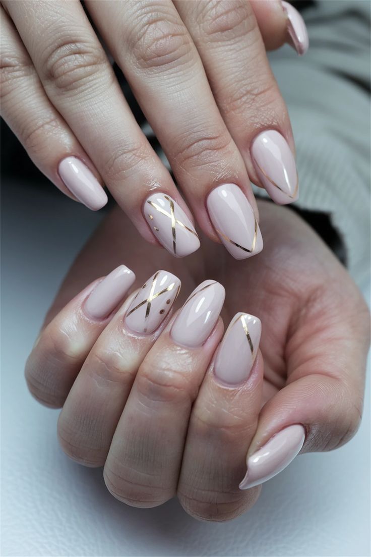 Sophisticated Nail Design with Soft Nude Base and Delicate Gold Accents