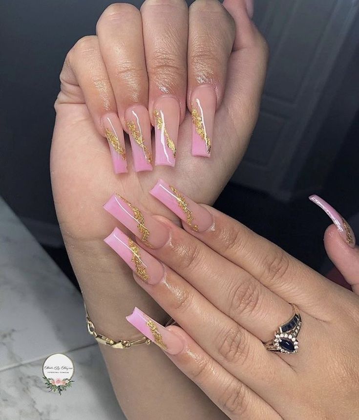 Elegant Pink Ombre Nails with Glamorous Gold Accents for a Trendy Look.