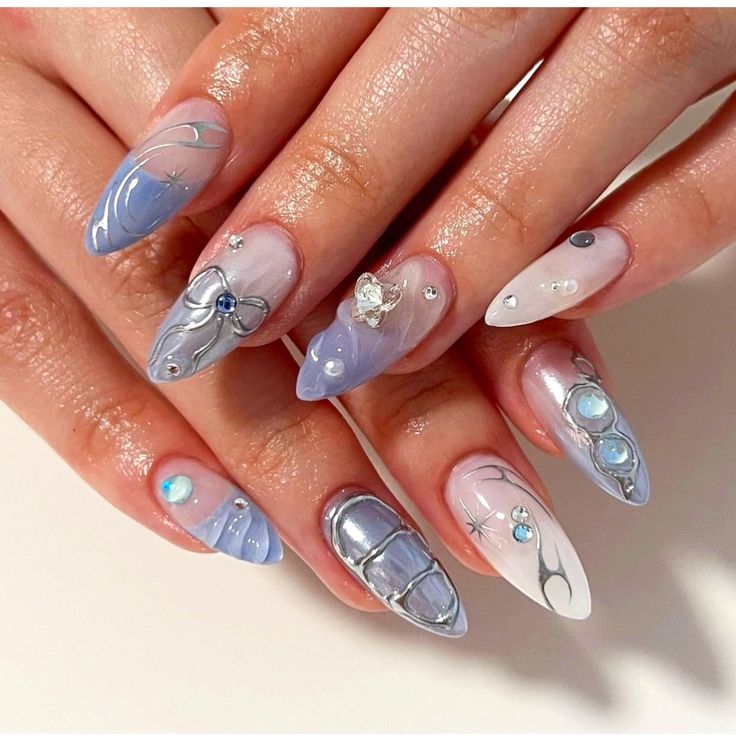 Sophisticated Nail Design: Soft Blue and White with Intricate Patterns and Accents.