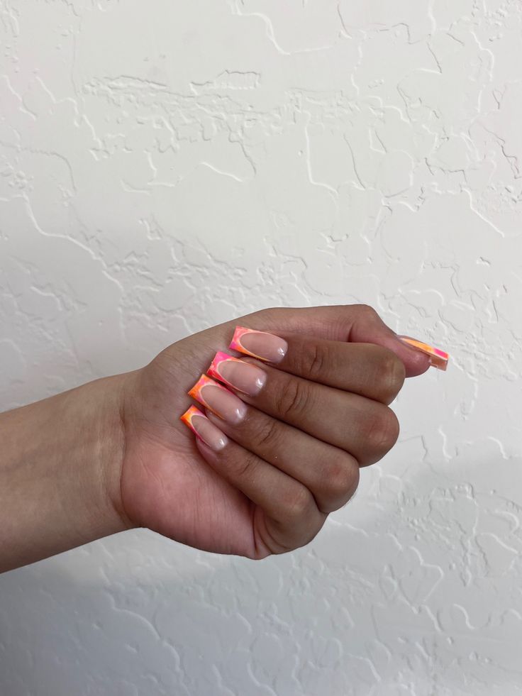 Vibrant Gradient Nail Design: Bold Orange and Pink Tips on a Nude Base