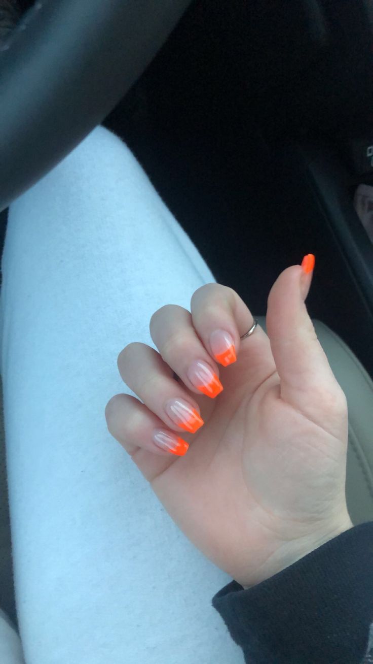 Bold Gradient Nail Design with Vibrant Orange Tips and Clear Base