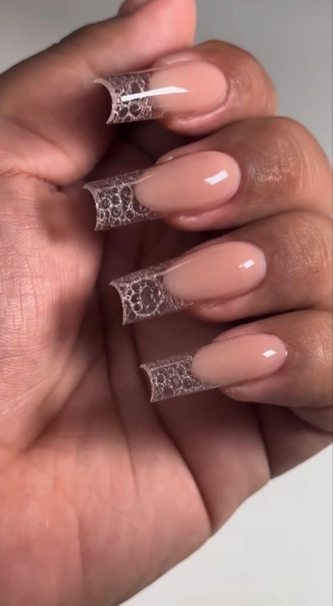 Sophisticated Nude Nail Design with Intricate Lace Tips for Any Occasion.