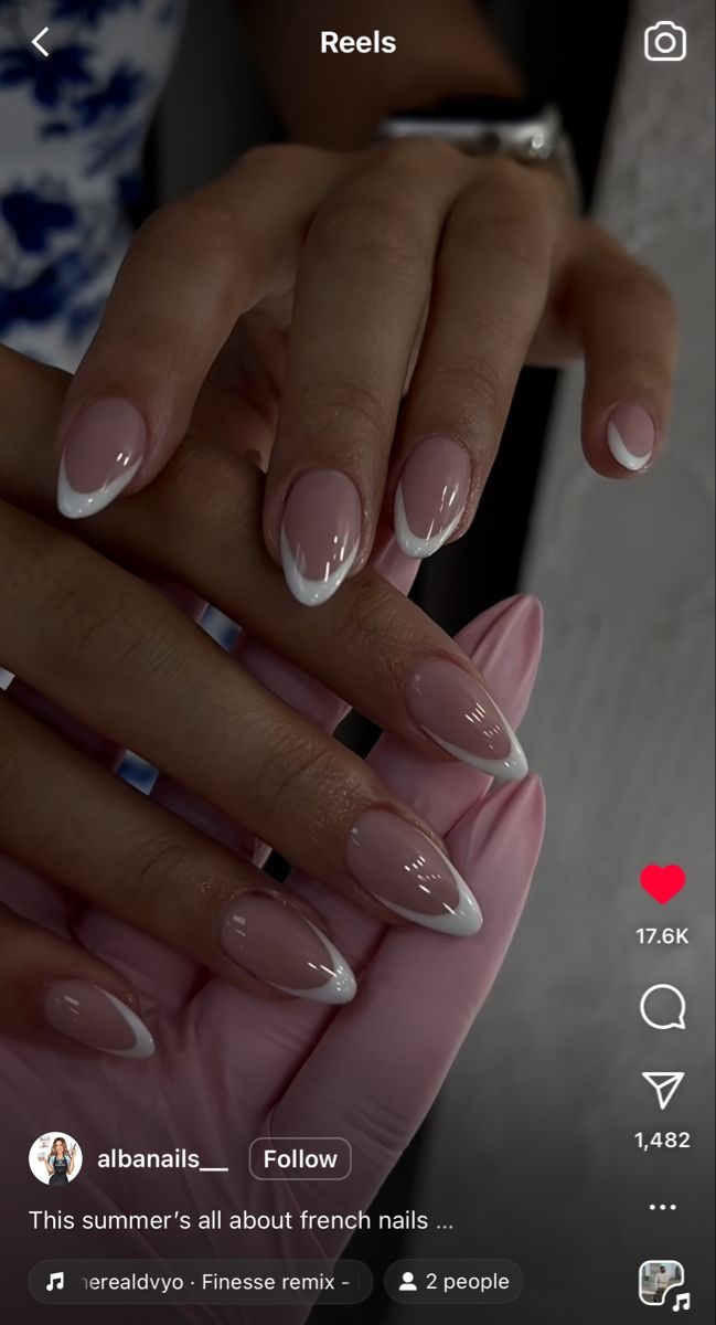 Chic Modern French Manicure with Sharp White Tips on Soft Nude Base.