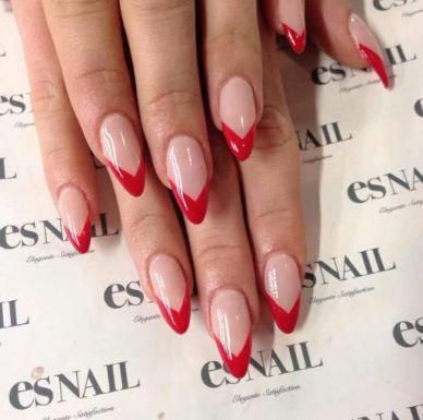 Chic Almond-Shaped Nails with Elegant Red French Tips on Nude Base.