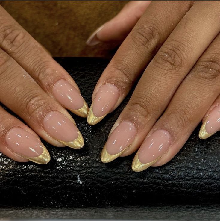 Chic Almond-Shaped Nails with Glamorous Gold Tips on Soft Nude Base.