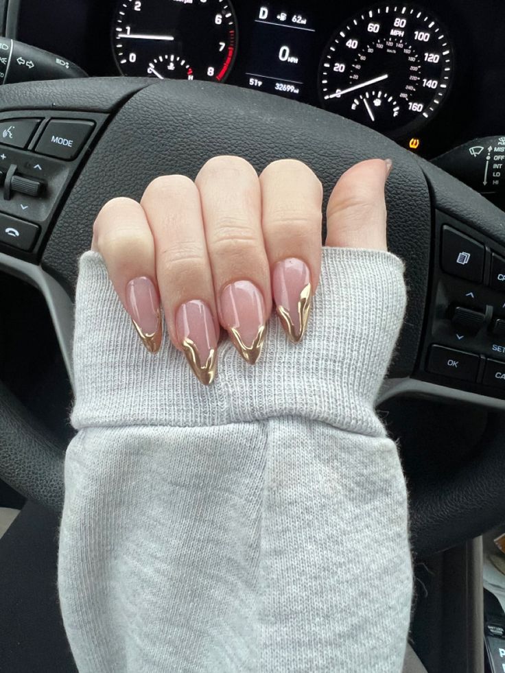 Elegant Glossy Nude Nails with Striking Gold Tips for a Modern Touch.