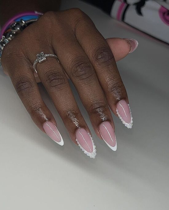 Sophisticated Almond-Shaped Nails: Soft Pink Base with Glossy White Tips and Pearl Embellishments.