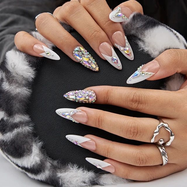 Glamorous Stiletto Nail Design with Colorful Rhinestones and Chic Accessories.