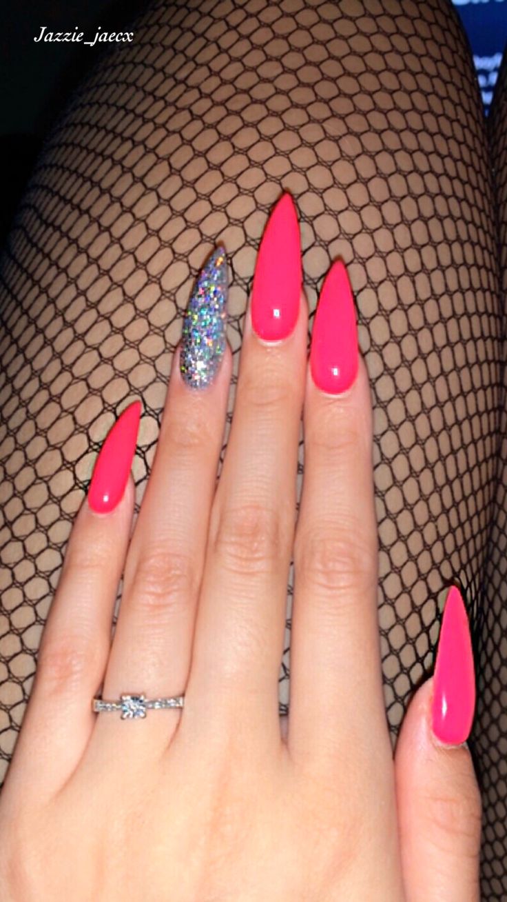 Bold Pink Stiletto Nails with Glitter Accent for a Glamorous Statement Look.