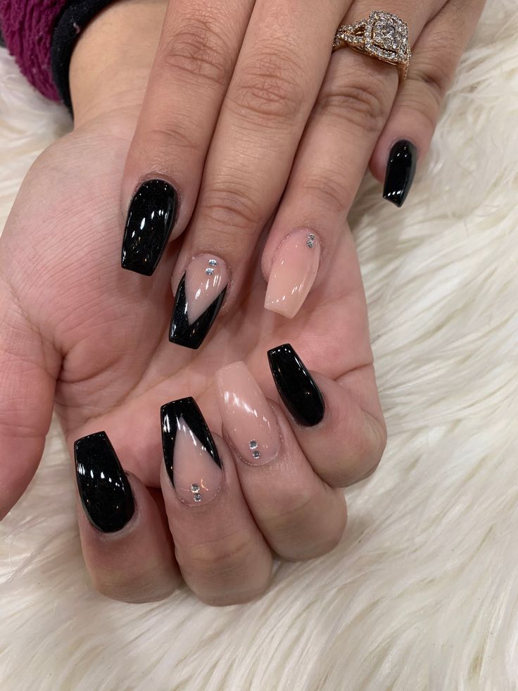 Edgy Chic Nail Design: Bold Black and Nude with Geometric Shapes and Rhinestones.