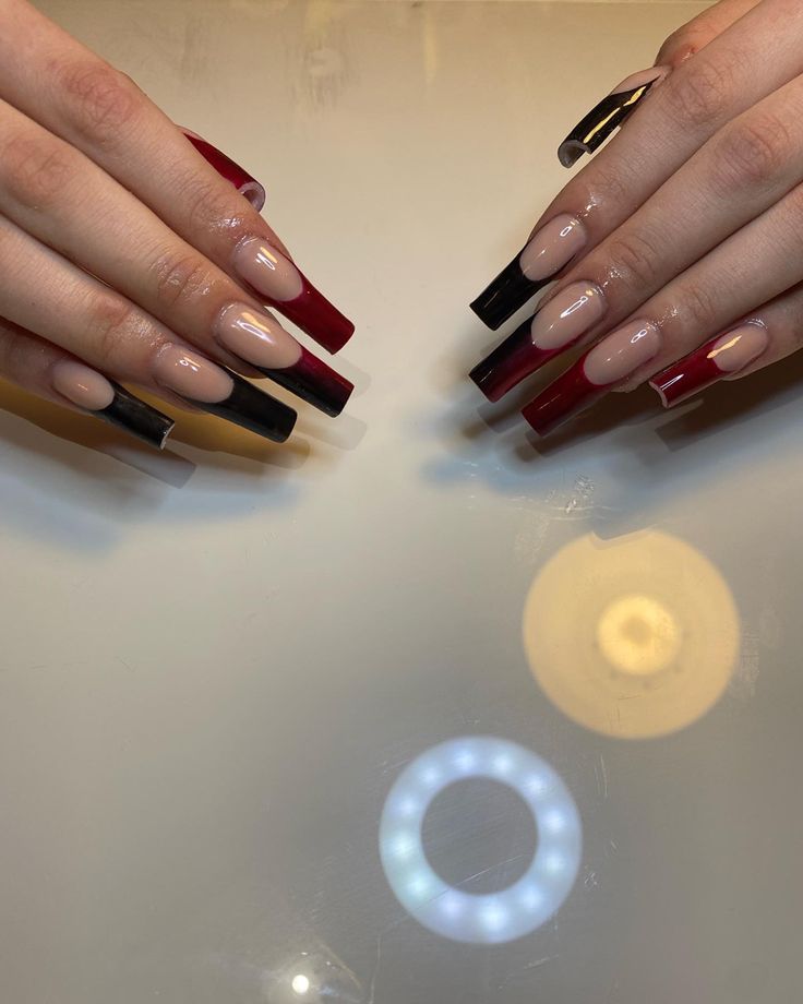 Bold and Sophisticated Nail Design with Vibrant Red and Sleek Black Accents.