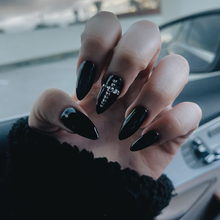 Glamorous Black Stiletto Nails with Glossy and Matte Finishes and Bold Embellishments