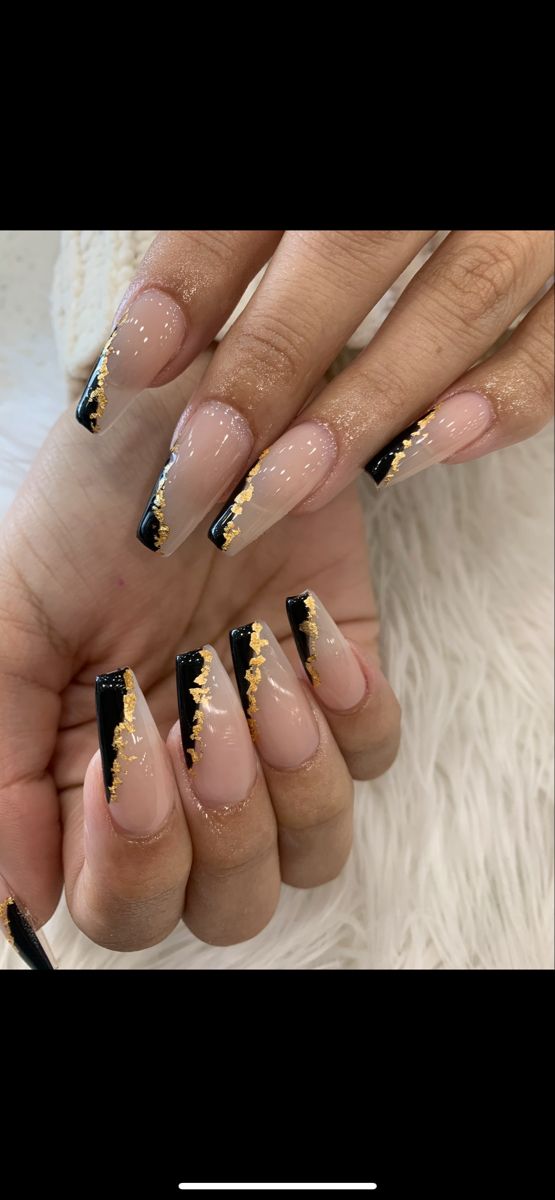 Sophisticated Nude and Black Nail Design with Glamorous Gold Accents