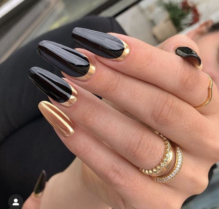 Chic Almond-Shaped Nails with Glossy Black and Metallic Gold Accents.