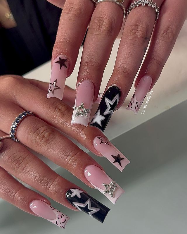 Chic Pastel Pink, Black, and White Nail Design with Star Motifs and Sparkling Embellishments