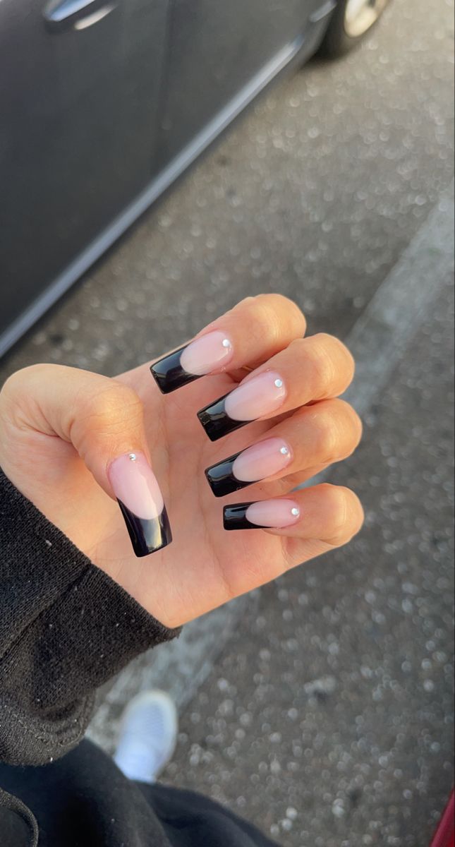 Chic Gradient Almond Nails with Black Tips and Gemstone Accents.