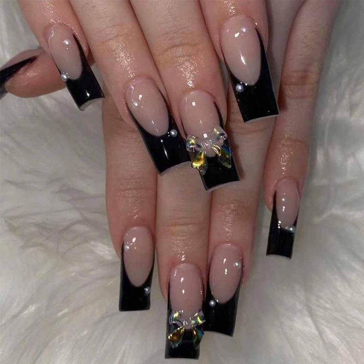 Chic Nail Design: Elegant Nude and Glossy Black Contrast with Jewels and Bow Accents