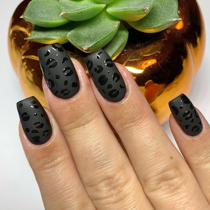 Bold Matte Black Nails with Chic Leopard Print Design for a Striking Look.