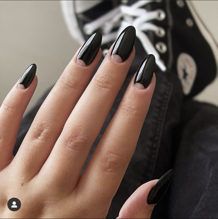 Chic Black Almond-Shaped Nails: A Bold and Elegant Contrast to Casual Footwear.