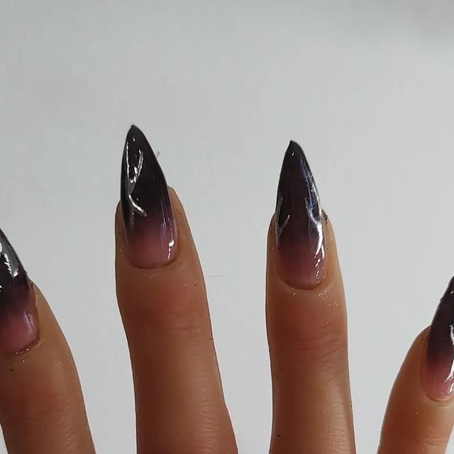 Elegant Stiletto Nails with Striking Black-to-Pink Gradient and Glossy Finish.