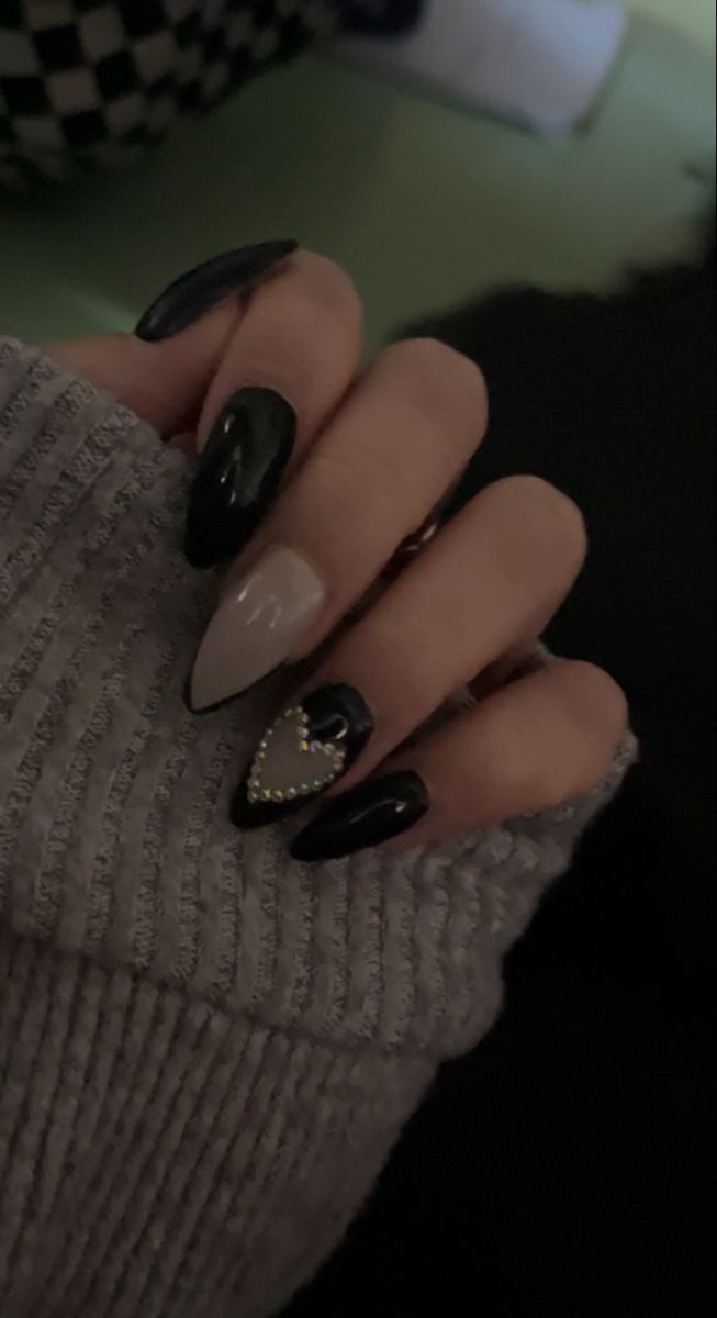 Chic Black and Nude Nail Design with Rhinestone Heart Accent for Elegant Versatility