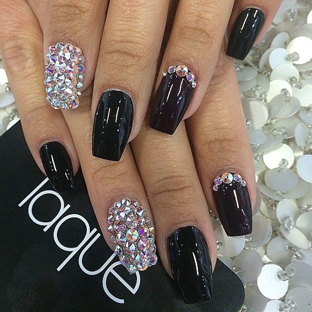 Chic Black Nail Design with Glossy Finish and Sparkling Gemstone Accents.