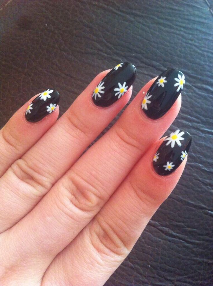 Whimsical Floral Nail Design: Glossy Black Base with Cheerful White Daisies.