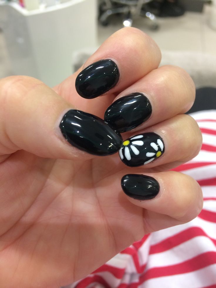 Chic Glossy Black Nail Design with Playful White Daisy Accents