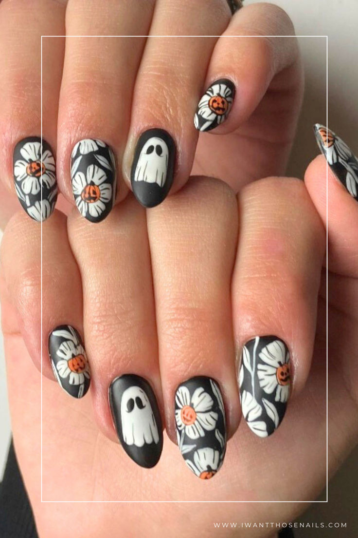 Whimsical Ghosts and Cheerful Daisies: Playful Halloween Nail Art Design.