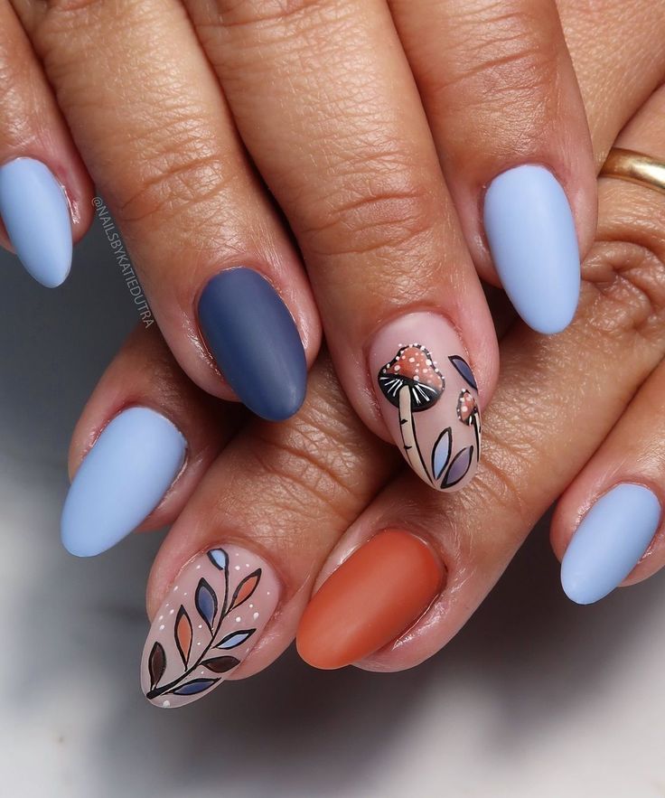 Vibrant Nail Design with Matte and Glossy Finishes, Soft Pastel Blues, Deep Navy, Warm Orange, and Intricate Floral Artwork.