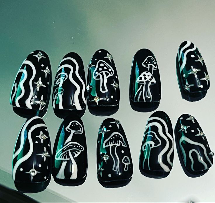 Playful Whimsical Nail Art: Black Tips with Vibrant Mushroom, Wave Patterns, and Rhinestone Accents.