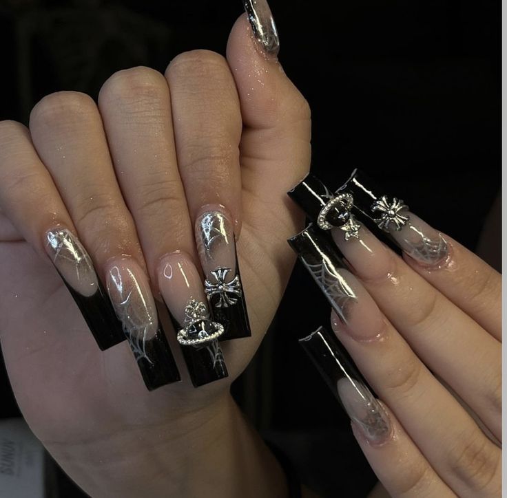 Chic Black and Clear Acrylic Nail Design with Glamorous Silver Embellishments and Bold Variations.