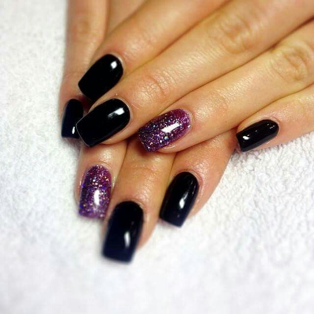 Sophisticated Nail Design: Glossy Black Base with Vibrant Purple Glitter Accents.