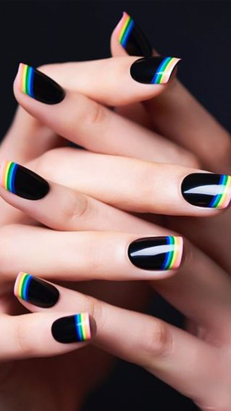 Bold and Playful Nail Design: Glossy Black Base with Multicolored Striped Tips.