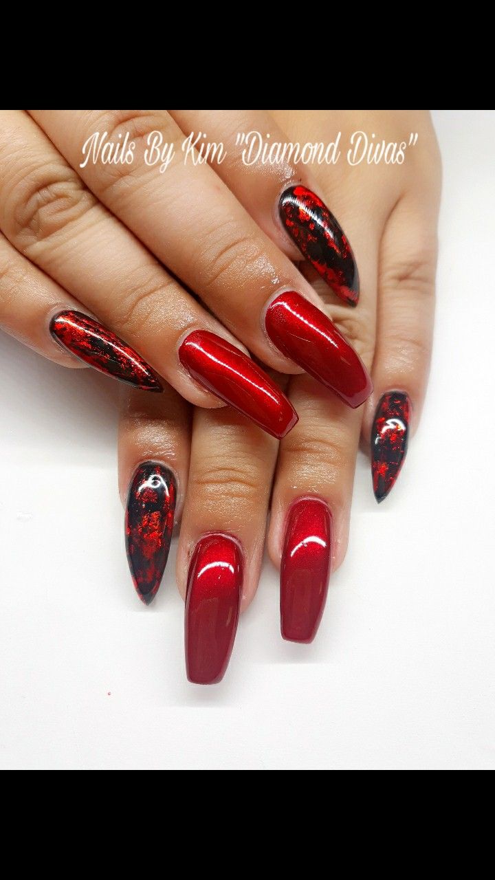 Bold and Sophisticated Red and Black Nail Design with Abstract Patterns and Long Tips.