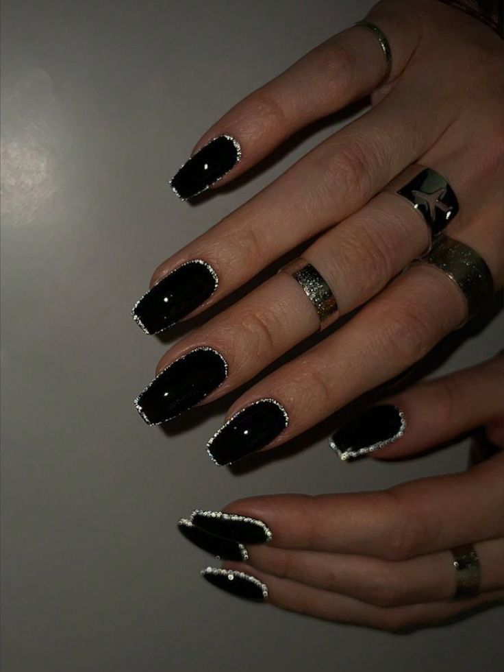 Sophisticated Black Nails with Sparkling Silver Rims: A Chic Contrast for Any Occasion.