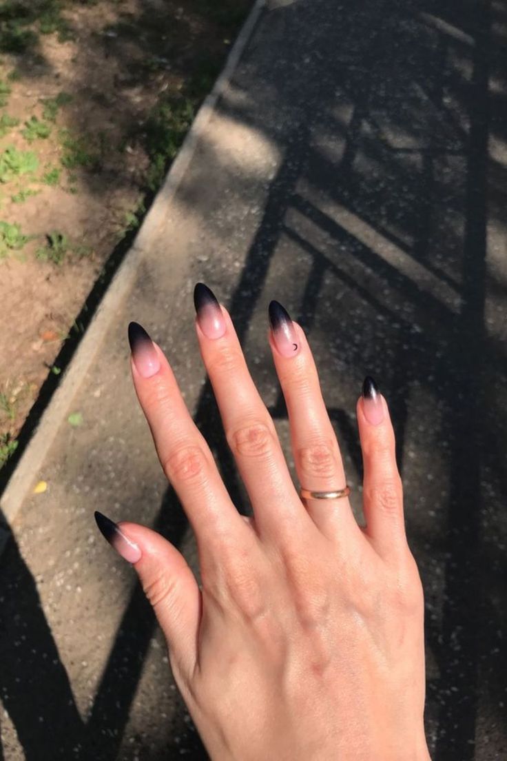 Striking Ombre Stiletto Nails: Sophisticated Nude to Black with Glossy Finish